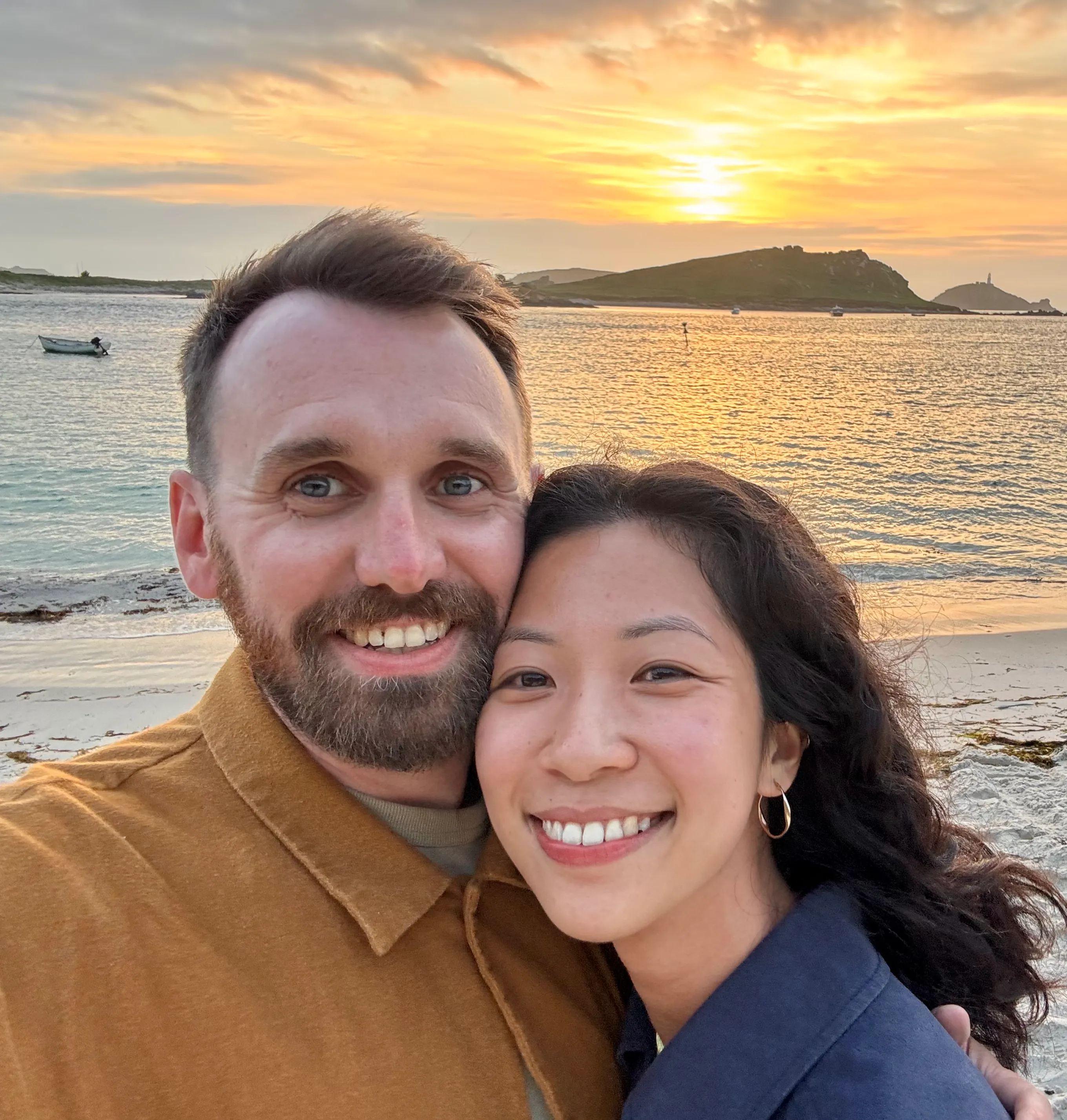 Peter and Brenda smiling together on a beach