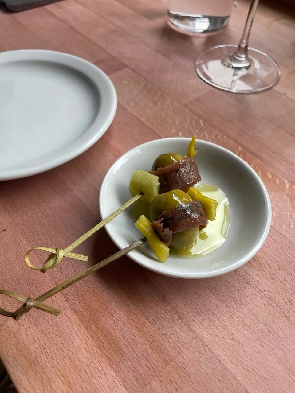 Two gildas sitting on a small white plate