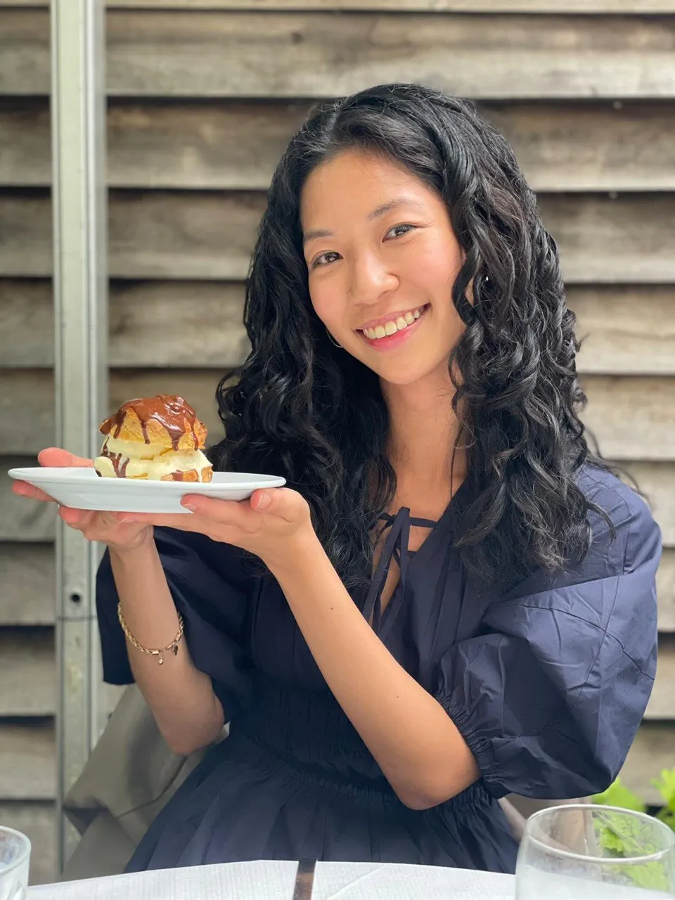 Brenda holding a mega profiterole
